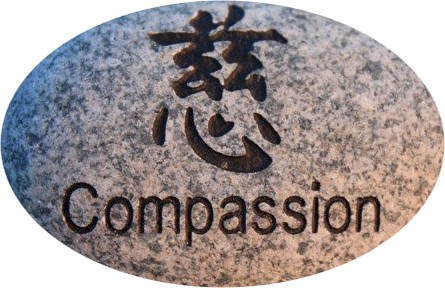 Thriving-Baby-Boomers - Compassion - Asian calligraphy for Compassion on a rock