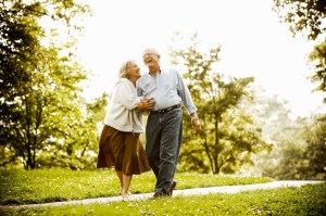 Thriving-Baby-Boomers - Cherish - Senior couple walking in park.