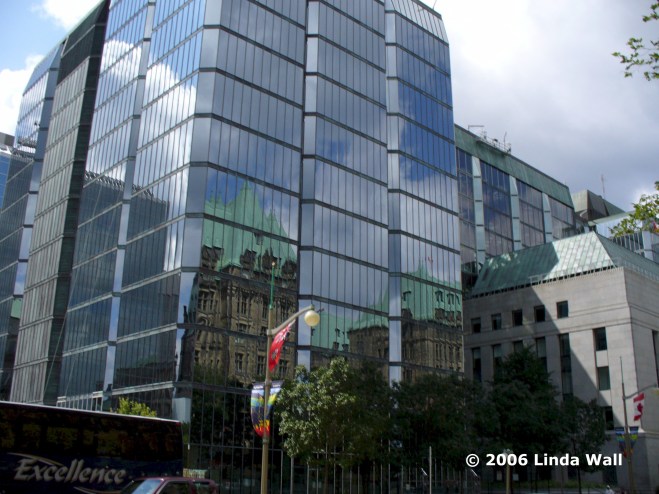 Thriving-Baby-Boomers - Long, Slow Travel - Canadian Parliament buildings reflected in modern glassed building, Ottawa, Canada 2006