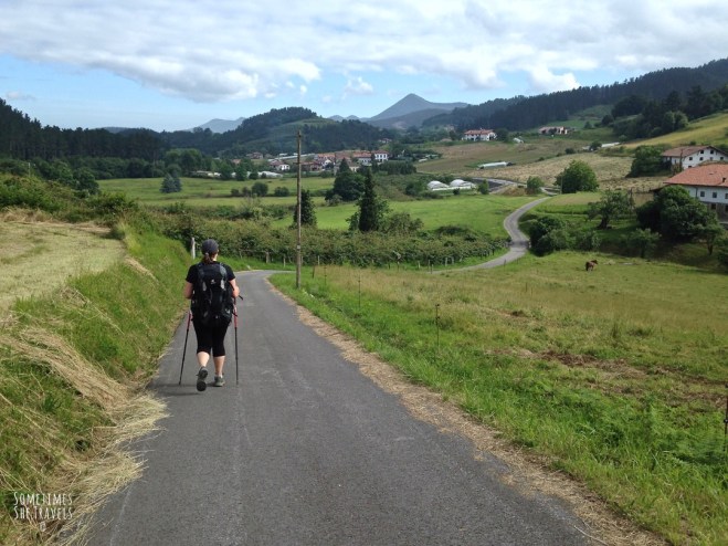 Thriving-Baby-Boomers - Backpacking - Lush green fields; backpacker walking the Camino